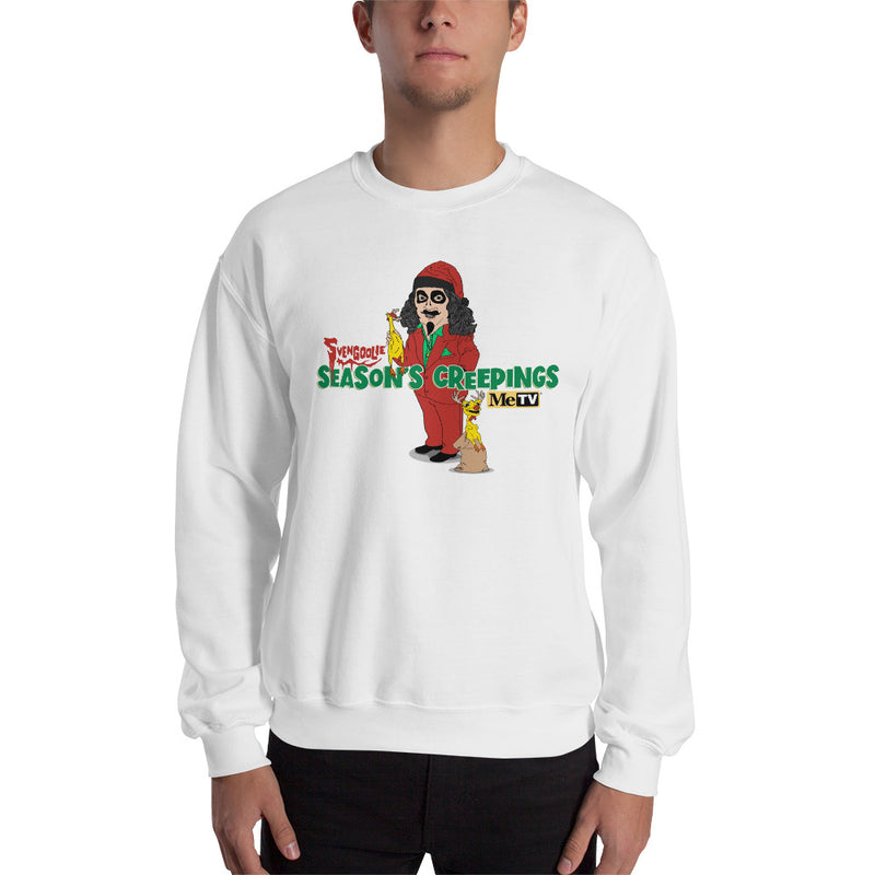 Man wearing white crewneck sweatshirt with cartoon Svengoolie in red suit holding a chicken, 'Season's Creepings' text and MeTV logo
