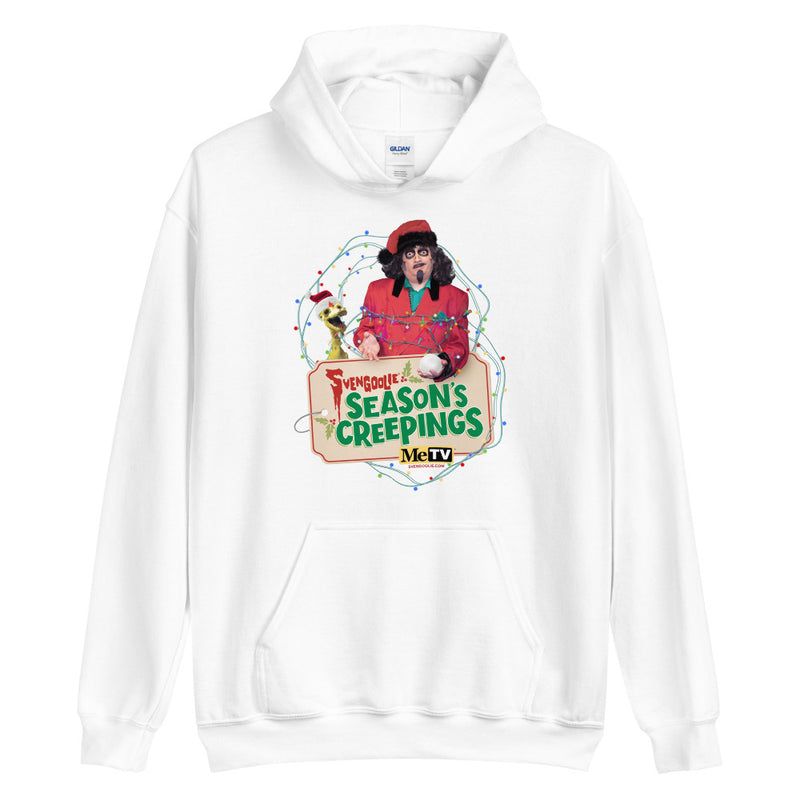 White pullover hoodie with Svengoolie in red suit holding a chicken, string lights, and "Season's Creepings" text plus MeTV logo.