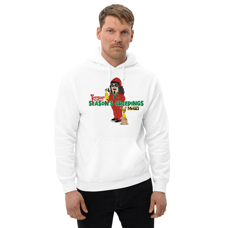 Man wearing White Hooded sweatshirt with cartoon Svengoolie in red suit holding a chicken, 'Season's Creepings' text and MeTV logo