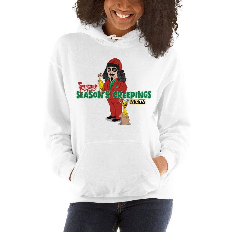 Woman wearing White Hooded sweatshirt with cartoon Svengoolie in red suit holding a chicken, 'Season's Creepings' text and MeTV logo