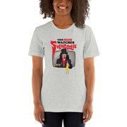 Model wearing gray t-shirt featuring Svengoolie holding a rubber chicken with the text 'This Mom Watches Svengoolie' in black and red above it.