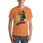 Orange tee with Svengoolie in top hat and black suit, at the top of a skyscraper, holding a skull, surrounded by rubber chickens, with 'SVENGOOLIE' in red letters over an orange sunset city.