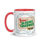White mug with red handle and red interior, wrapped in string lights, with a tag reading Svengoolie & Season's Creepings and MeTV logo.