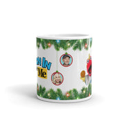 White ceramic mug with green pine garland and string lights, a man in a cap and a woman in ornaments, red puppet, and 'Toon In With Me' text.