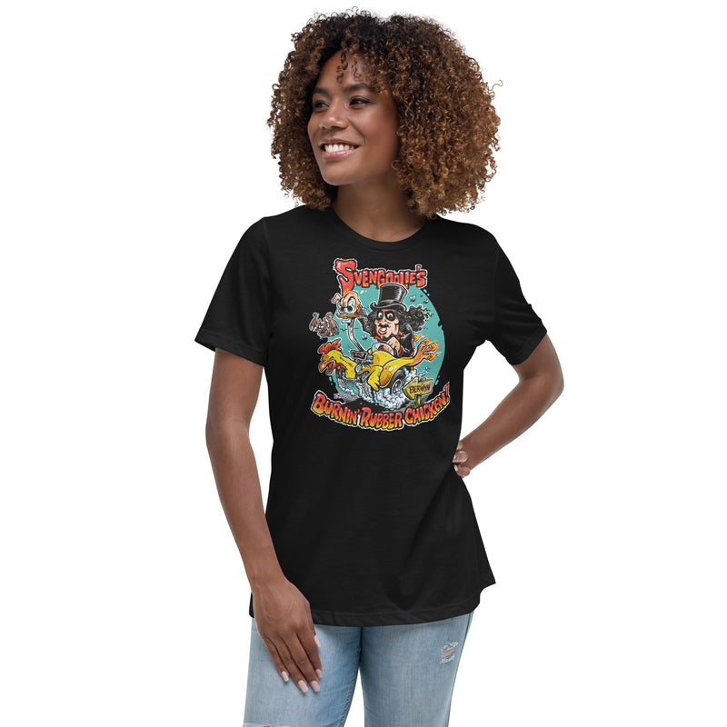 Black women's relaxed t-shirt with cartoon Svengoolie in top hat on a flaming car shaped like a chicken, text 'Svengoolie's Burnin' Rubber Chicken!'.