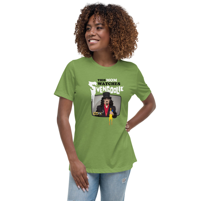 Model wearing green t-shirt featuring Svengoolie holding a rubber chicken with the text 'This Mom Watches Svengoolie' in black and white above it.